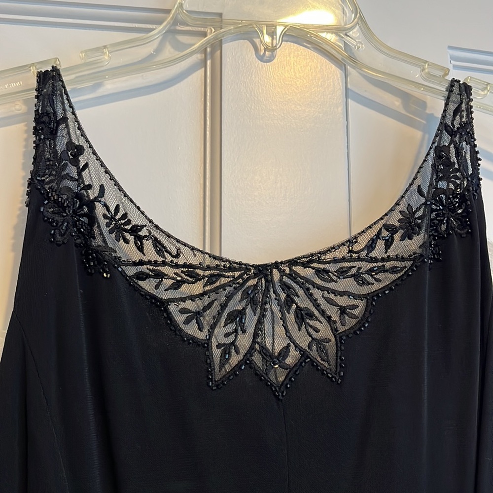 Black evening gown with beaded lace neckline.